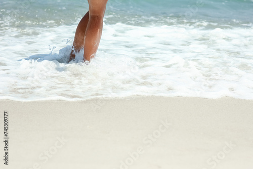A Feet and footprints by the seashore in nature travel vacation background © Kostia