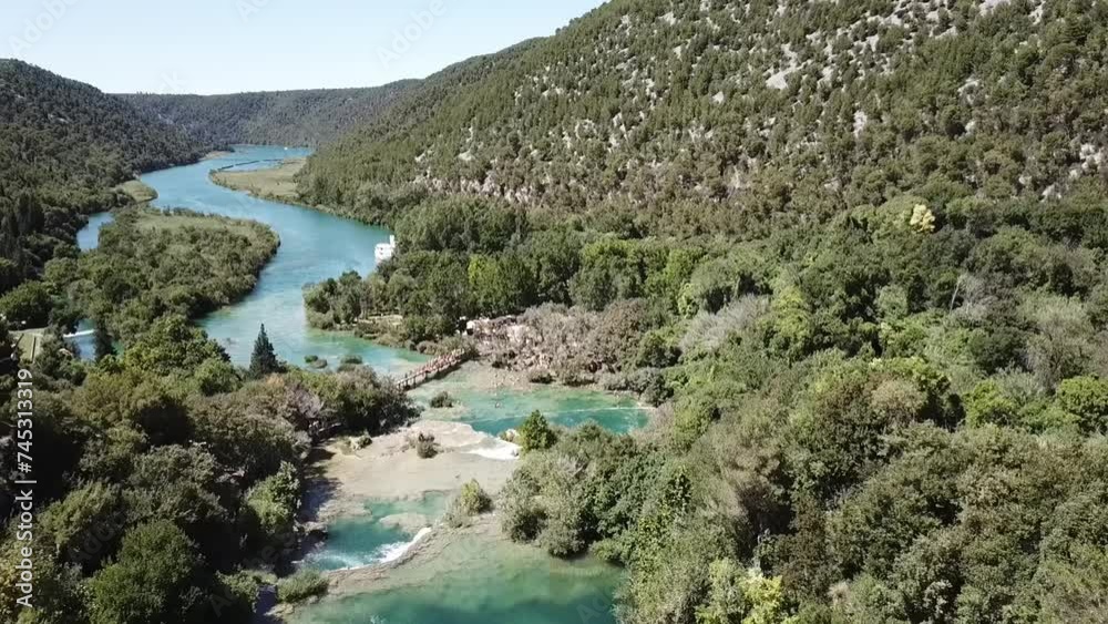 Aerial shot of a beautiful waterfall between trees on a sunny day, above Karka Falls, Croatia Aerial shot of a beautiful waterfall between trees on a sunny day, above Karka Falls, Croatia