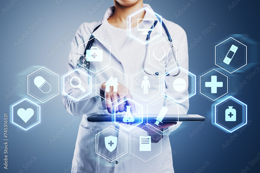 Close up of female doctor hand pointing at tablet with creative glowing blue medical interface hologram on blurry background. Digital healthcare, future and research concept. Close up of female doctor hand pointing at tablet with creative glowing blue medical interface hologram on blurry background. Digital healthcare, future and research concept.