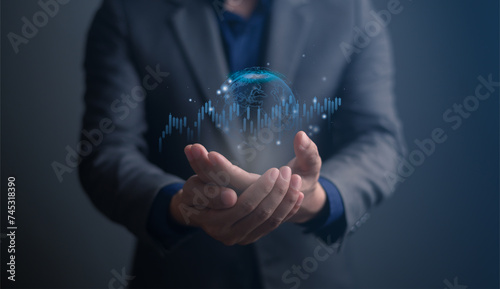 Hand holding hologram of planet Earth with glowing chart of investment financial data. Graph stock market with rising candlesticks. Infographic elements transparent global world