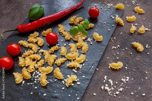 Uncooked Creste di Gallo pasta and ingredients for it cooking photo