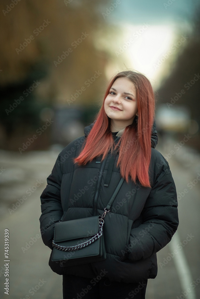 Portrait of a young beautiful long-haired girl on a spring city street. Portrait of a young beautiful long-haired girl on a spring city street.