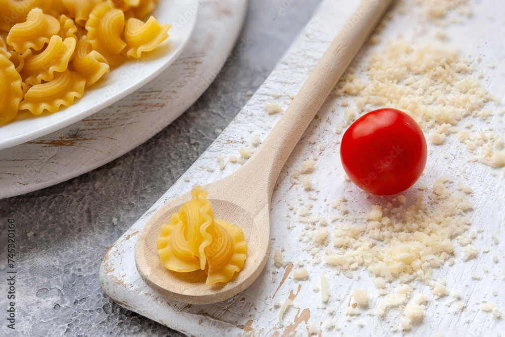 Uncooked Creste di Gallo pasta and ingredients for it cooking Uncooked Creste di Gallo pasta and ingredients for it cooking
