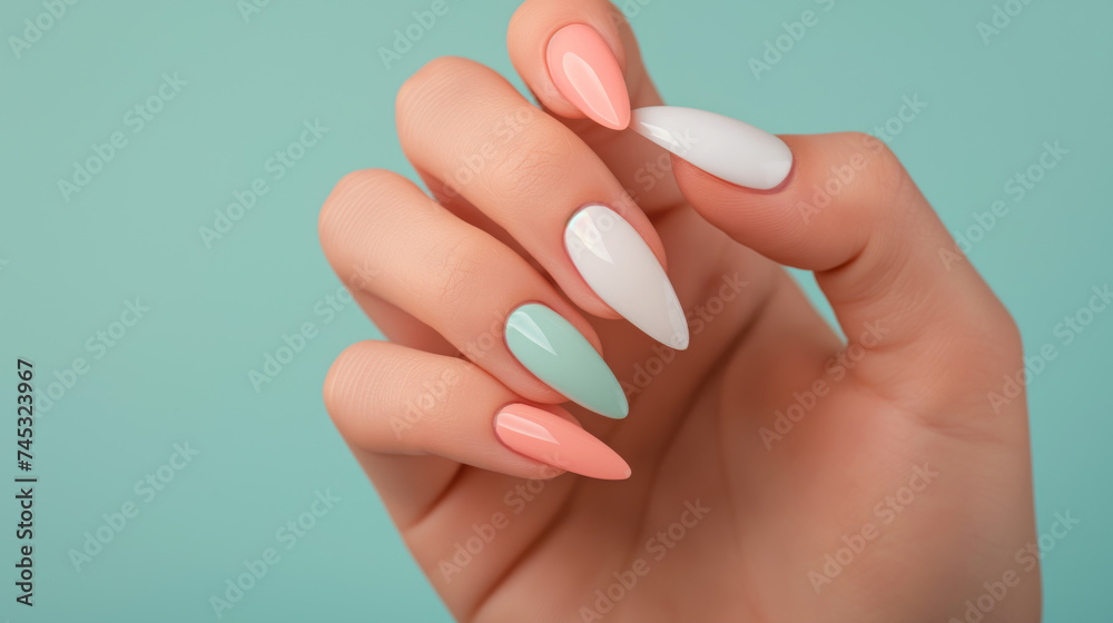 Pastel Nail Beauty - Elegant Female Hand with Multicolored Manicure on Mint Background Pastel Nail Beauty - Elegant Female Hand with Multicolored Manicure on Mint Background
