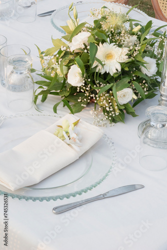 Wedding table decoration with fresh colorful flowers, plates and candles