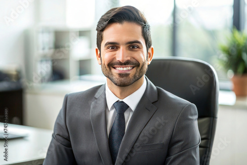Young Hispanic Businessman in Business Suit: Portrait of Satisfied Boss Smiling and Looking at Camera Inside Office © Tapos