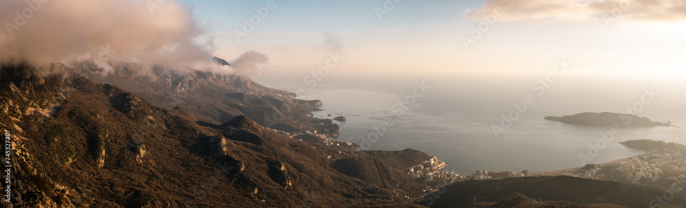 View from mountains to the coast and the sea during sunset, Adriatic sea, Budva, Monenegro