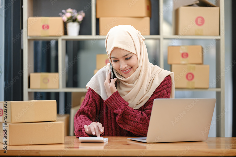 Young beautiful SME online business owner using smartphone to connect her client. Young beautiful SME online business owner using smartphone to connect her client.