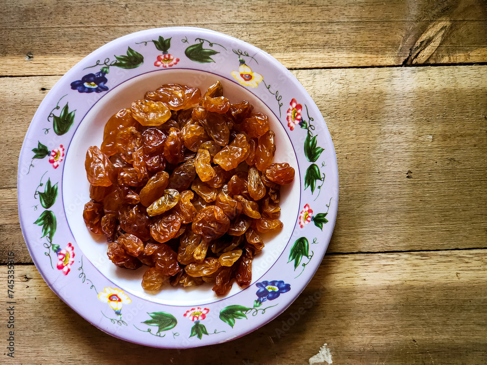 Raisins or dried grapes in a small plate Raisins or dried grapes in a small plate