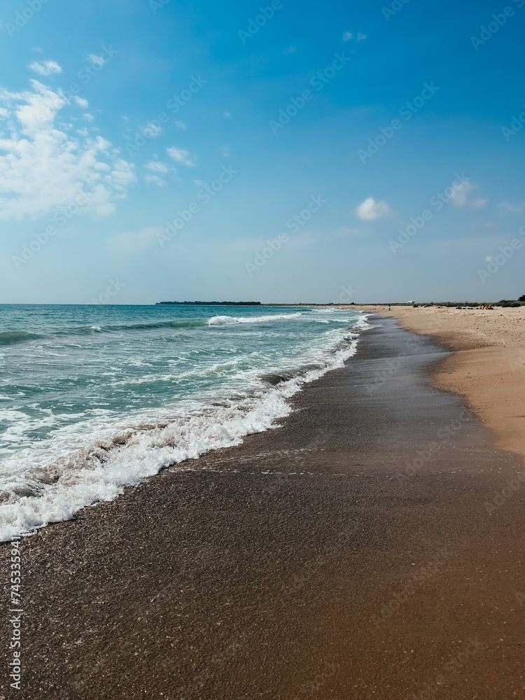 Sea blue aquamarine waves line sunny sand beach. Soft wave of ocean foam.