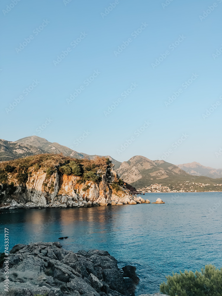 Top view Montenegro Sutomore stones beach blue turquoise Adriatic sea water mountains on sunset.