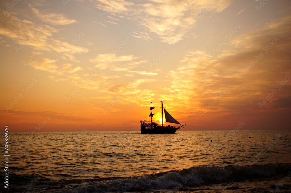 The ship sails on the sea during sunset. Black sea. Sea voyage.