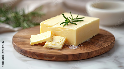 Butter on a wooden board on the table, kitchen background