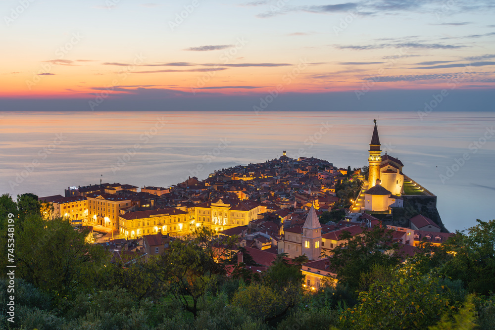 Piran, Slovenia - panorama of a beautiful seaside town located on the Adriatic Sea. Slovenian tourist attraction and travel destination. Sunset over Piran