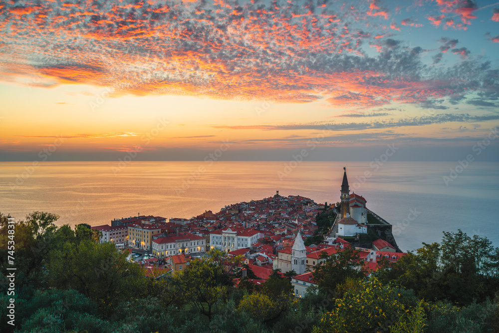 Piran, Slovenia - panorama of a beautiful seaside town located on the Adriatic Sea. Slovenian tourist attraction and travel destination. Sunset over Piran