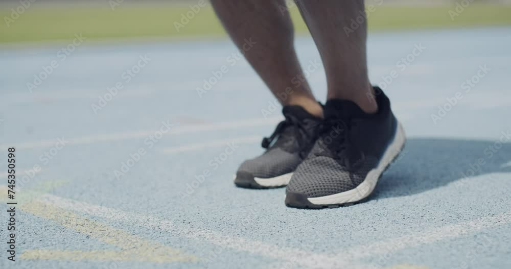 Person, runner and tie shoes for race, sprint or running exercise in outdoor workout on stadium track. Closeup of fitness athlete tying or getting ready for training or competition or challenge Person, runner and tie shoes for race, sprint or running exercise in outdoor workout on stadium track. Closeup of fitness athlete tying or getting ready for training or competition or challenge