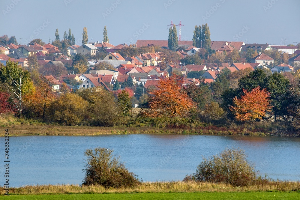 Autumn view of pond and Osova Bityska village