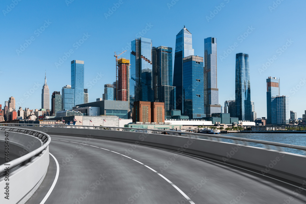 Naklejka premium Empty urban asphalt road exterior with city buildings background. New modern highway concrete construction. Concept of way to success. Transportation logistic industry fast delivery. New York. USA.