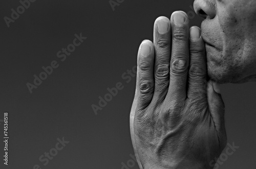  black man praying to god with hands together Caribbean man praying on black background with people stock photos stock photo