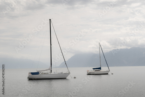 Lake Geneva sailboats in monotone against the Swiss Alps