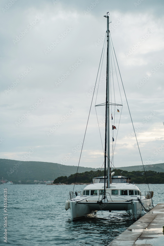 Modern yacht and sailboat moored to pier in central marina of Biograd na Moru of Croatia