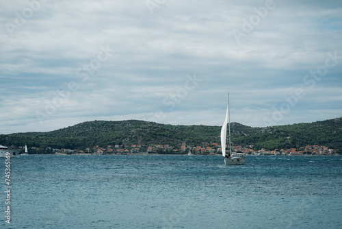 Modern boat sailing near shore, central marina of Biograd na Moru of Croatia