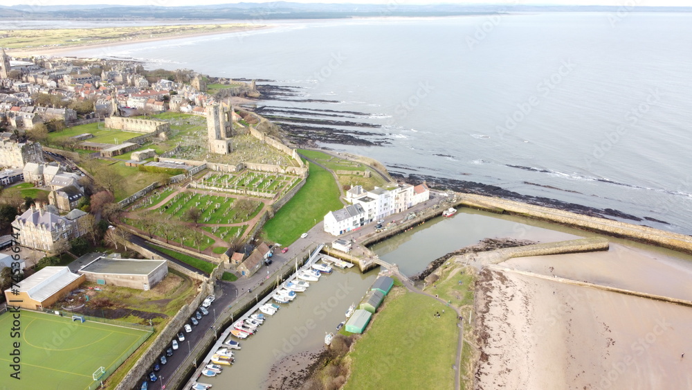 an aerial view of the city and river with the coast in the background