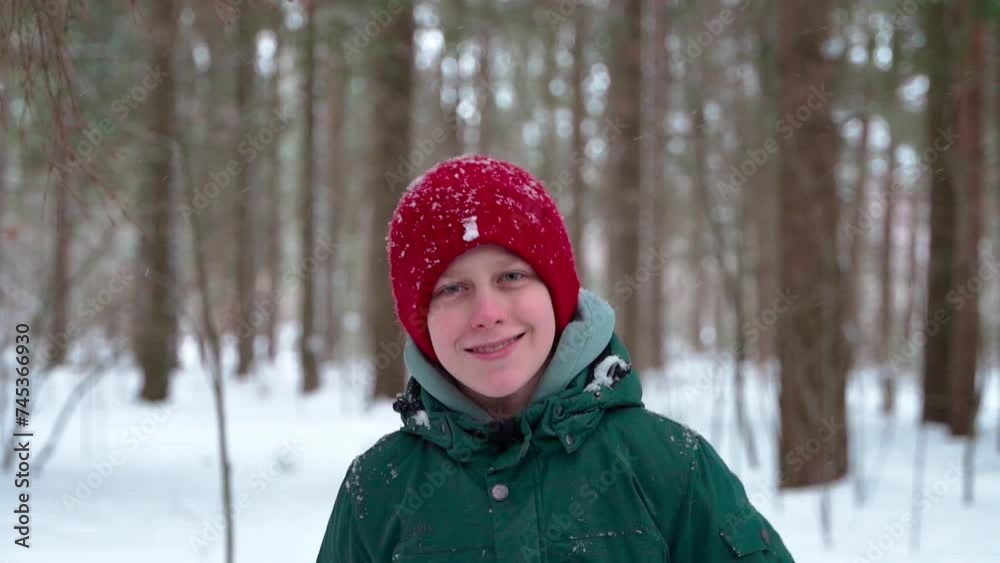Young boy smiling and walking towards camera in winter forest Young boy smiling and walking towards camera in winter forest