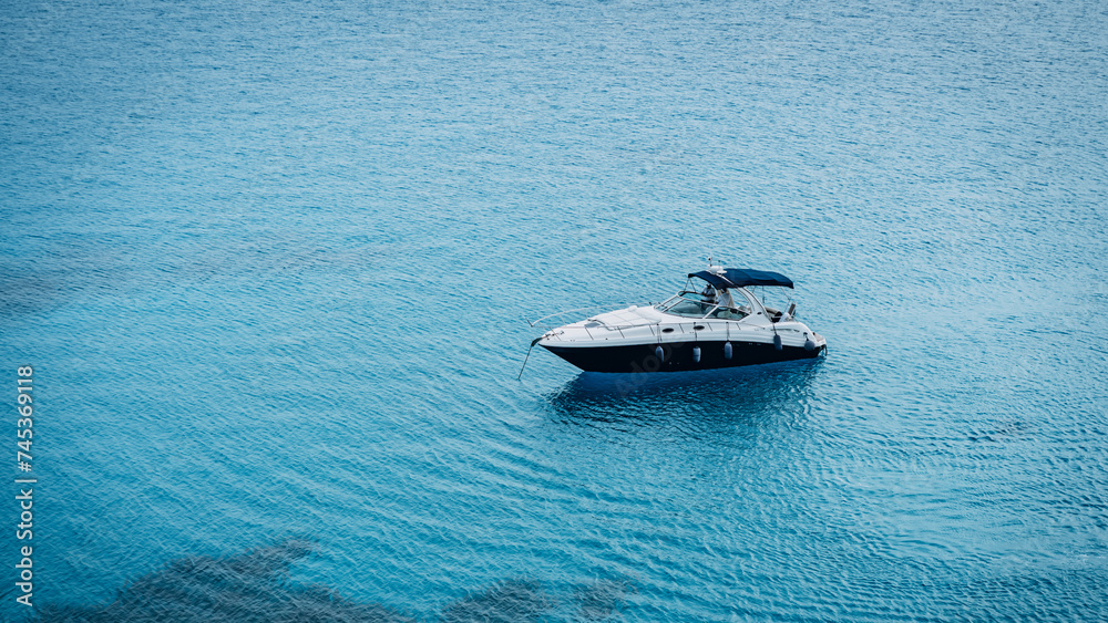 Modern yacht sailing on turquoise clear sea water in Cape Greco National Park, Cyprus Modern yacht sailing on turquoise clear sea water in Cape Greco National Park, Cyprus