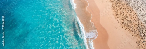 Aerial Shoreline Beauty - The stunning natural contrast of sand and sea along a gently curving shoreline.