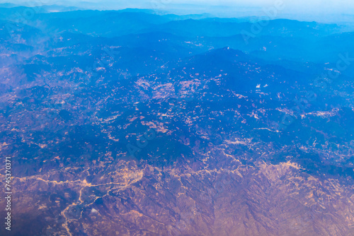 Flying airplane over Mexico Clouds Sky Volcanoes Mountains City desert.