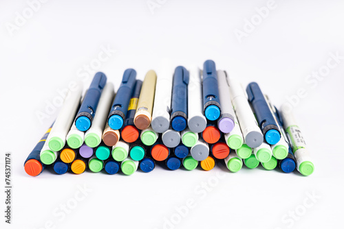 Insulin pens. Isolated on white background. Insulin injector pens for hormonal therapy of diabetic patients. Multi-colored syringe pens for insulin injections