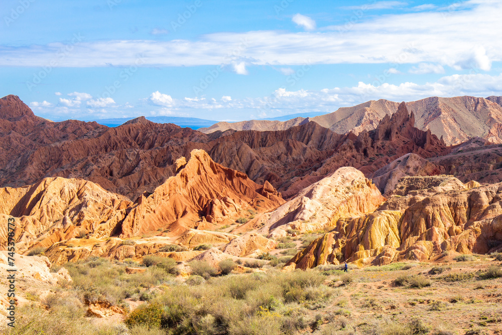 landscape of Skazka canyon on Issyk-Kul lake. Rocks Fairy Tale famous destination in Kyrgyzstan. Mountain like great wall of china and Rainbow Mountains of Danxia or Antelope crevice USA. Central Asia