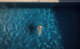 Man Swimming in Pool of Water