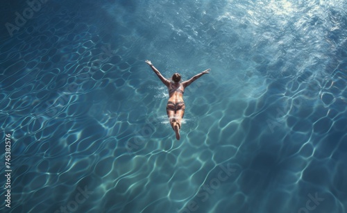 Woman swimming in pool of water. 