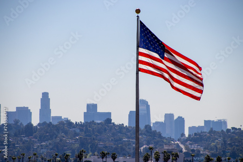 USA Flag flying with Los Angeles skyline in background