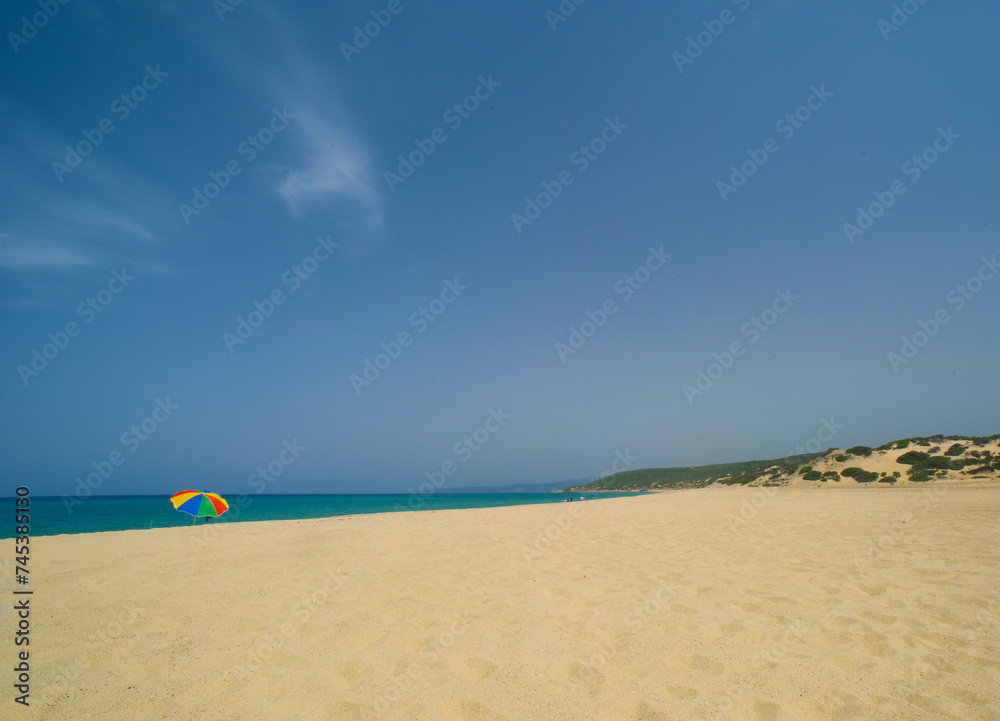 colourful umbrella at beach and blue sky Piscinas, Sardinia, Italy