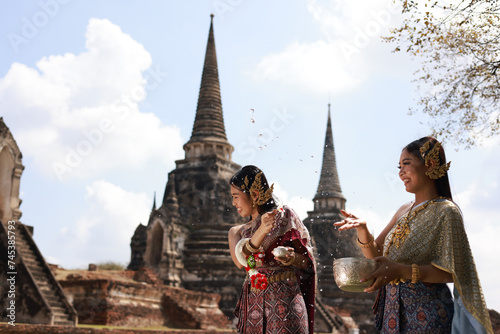 Funny aisa women Throw and splash water to each other on Songkran festival day. Having water fight in Wat Phra Si Sanphet   Ayutthaya  Thailand