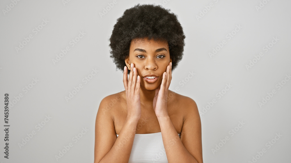 Portrait of a beautiful african woman with curly hair isolated on a white background, touching her face gently. Portrait of a beautiful african woman with curly hair isolated on a white background, touching her face gently.