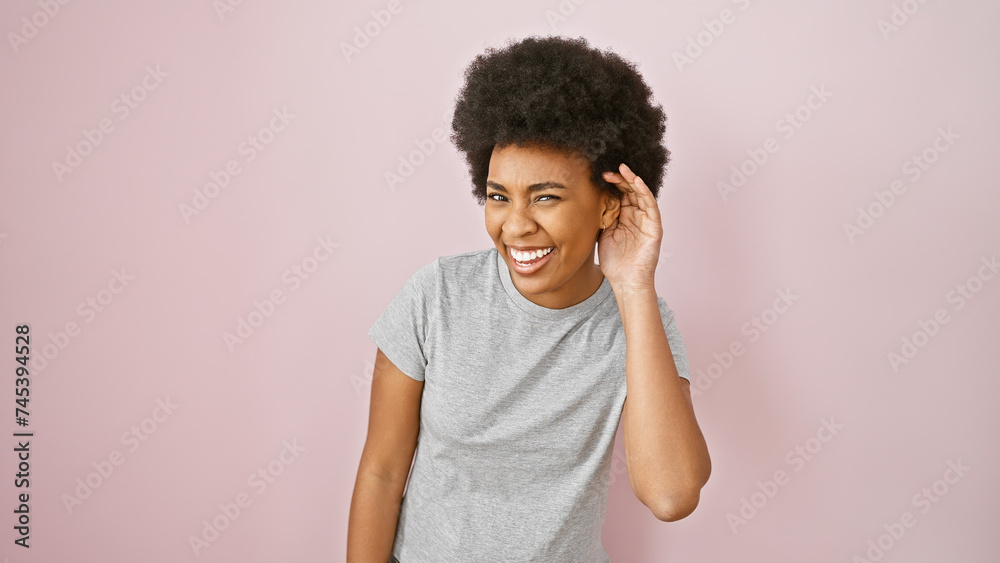Smiling african american woman with curly hair against a pink isolated background, portraying positivity and beauty. Smiling african american woman with curly hair against a pink isolated background, portraying positivity and beauty.