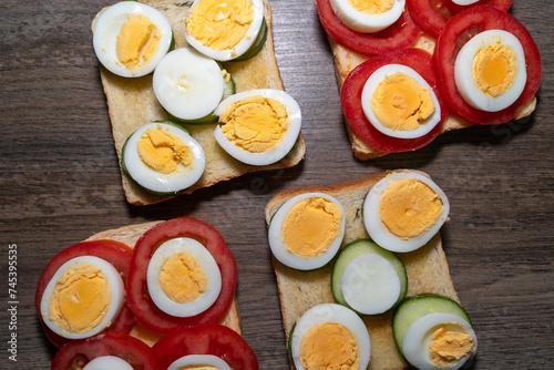 Toasted bread with boiled eggs, tomatoes and cucumber slices 