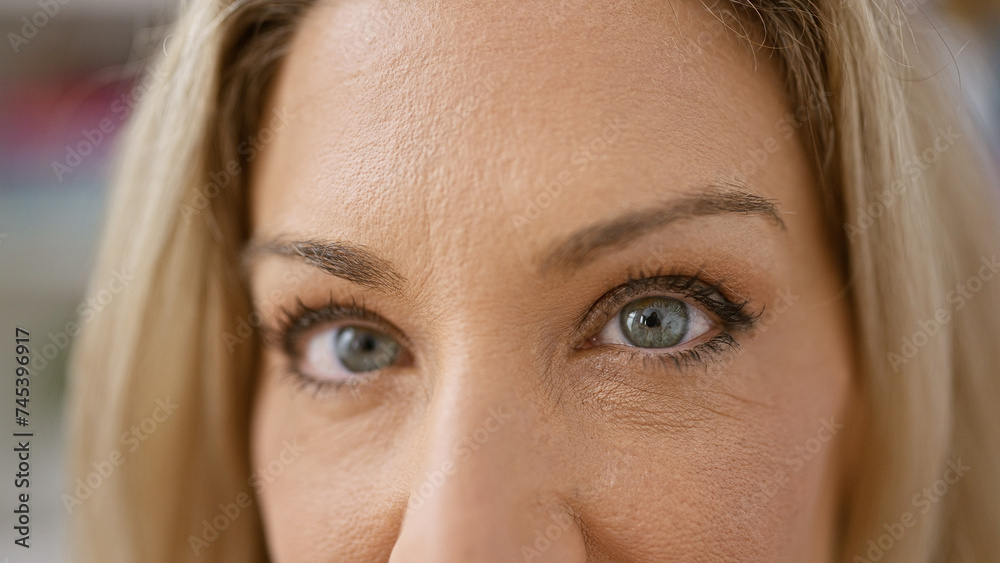 Young blonde woman close up of eyes smiling at home Young blonde woman close up of eyes smiling at home