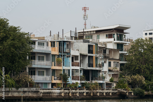 Old Waterfront Apartment Buildings with Balconies Overlooking the Rive © Maria