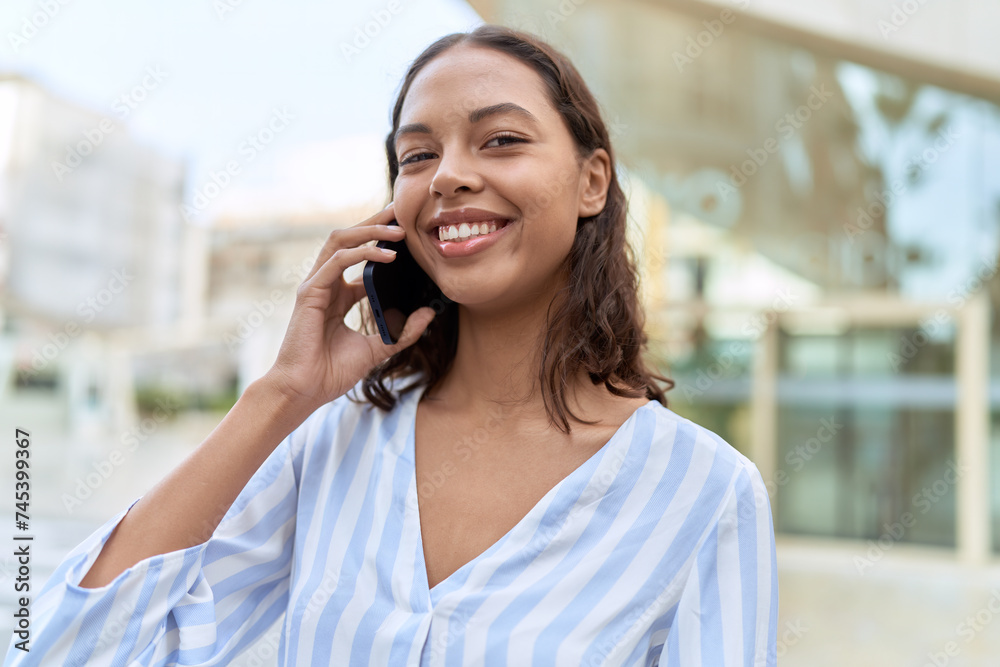 Young african american woman smiling confident talking on the smartphone at street Young african american woman smiling confident talking on the smartphone at street