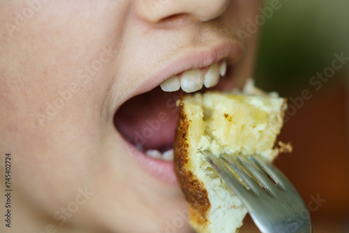 Crop anonymous young girl eating delicious potato omelette