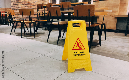 Bild auf Leinwand Banner on floor of yellow colour with caution wet floor