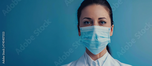Resolute Female Nurse with Mask Against Blue Background
