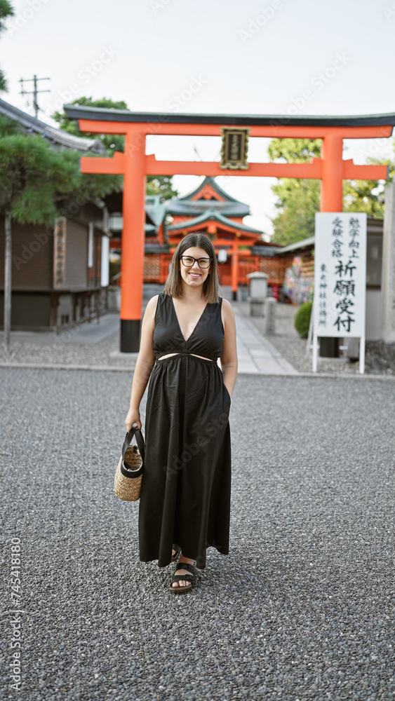 Beautiful hispanic woman with glasses laughing and walking cheerfully towards camera at yasaka temple, kyoto - enjoying the joy of traditional japanese higashiyama architecture.