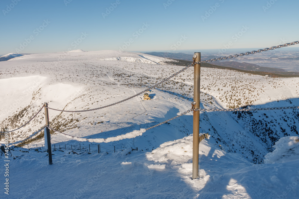 Steel railing tube with a chain on danger path from Silesian house to Snezka, mountain on the border between Czech Republic and Poland. Steel railing tube with a chain on danger path from Silesian house to Snezka, mountain on the border between Czech Republic and Poland.