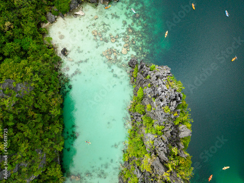 Turquoise clear water with kayaks. Big Lagoon in Miniloc Island. El Nido, Palawan. Philippines.